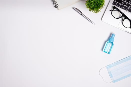 The equipment to protect COVID-19, blue mask and hand cleaner gel for preparing to work from home Isolated on white background concept.