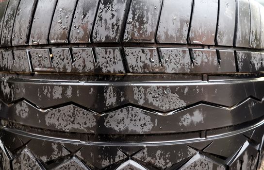 Damaged and worn old black tires on a stack. Tire tread problems. Solutions concept.