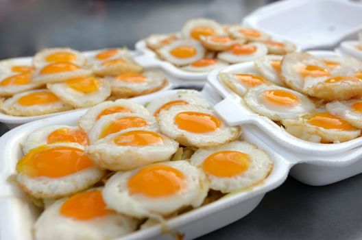 Quail eggs fried in a foam box, Fresh organic quail fried eggs.