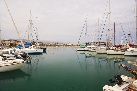 RETHYMNO, THE CRETE ISLAND, GREECE - MAY 30, 2019: Beautiful big white yachts in the seaport of the Rethymno, the Crete island, Greece