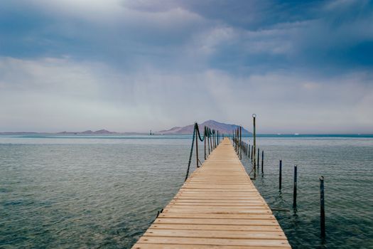 Old wooden pier on the Red sea at overcast day