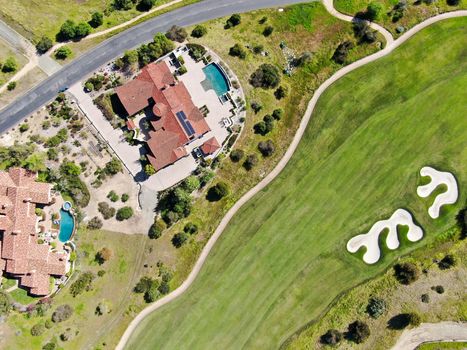 Big luxury villa with pool located next the golf course and green valley in a private community, San Diego, California.