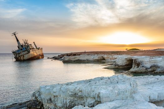 Abandoned rusty ship stranded ashore  in the sunset rays at Peyia village, Paphos