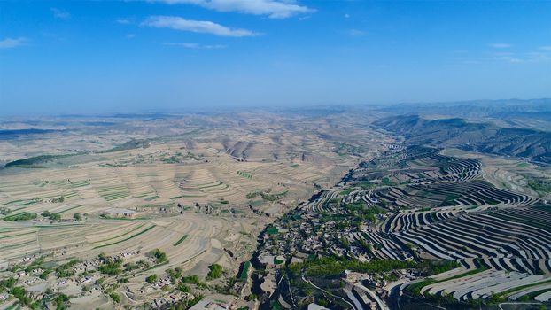 Aerial view of terraced farm field mass production during summer dry season in Tianshui, Gansu Province, China.