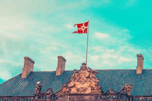 National Danish flag on the Royal Palace Amalienborg. Copenhagen, Denmark