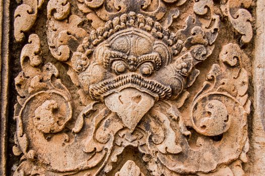 Bas relief carving of the Hindu deity Garuda guarding the entrance to a chapel at Banteay Srei Temple, Angkor, Cambodia.