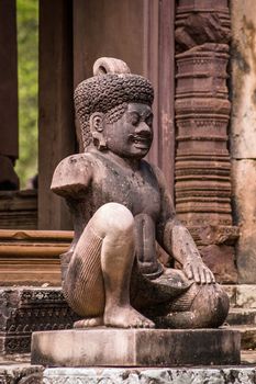 One of the Yaksha, or tree genie, guardians at the ancient Khmer temple of Banteay Srei, Angkor, Cambodia.