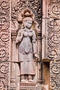 Beautifully carved bas relief of a Devata on the West Wall of the principal prasat of Banteay Srei Temple, Angkor, Cambodia.