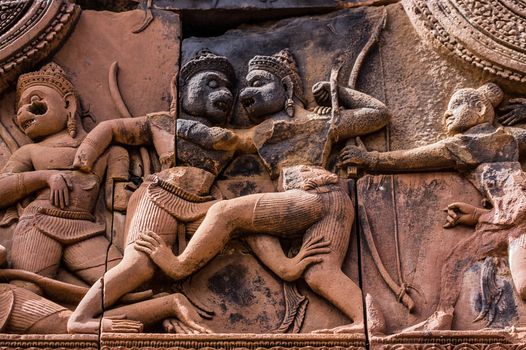 Ancient Khmer carving of the combat between Sugriva and Valin. The Hindu epic, Ramayana describes how Sugriva defeated his brother to rule the monkey kingdom. Banteay Srei Temple, Angkor, Cambodia.