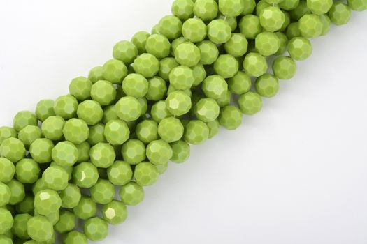 Beautiful Light green Glass Sparkle Crystal Isoalted Beads on white background. Use for diy beaded jewelry