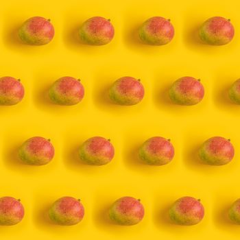 Pattern with ripe mango on yellow background. Top View. Copy Space. Pop art design, creative summer concept. Mango in minimal flat lay style.	
