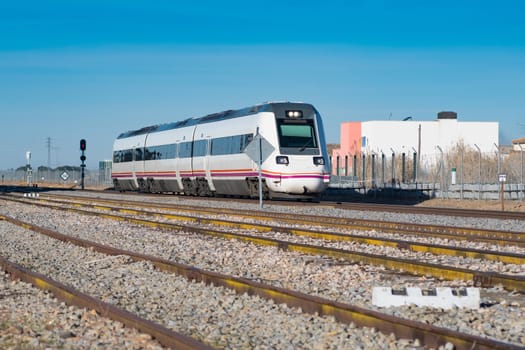 Passenger train passing through the highway approaching a station