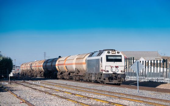 Dangerous goods train passing the track approaching a station