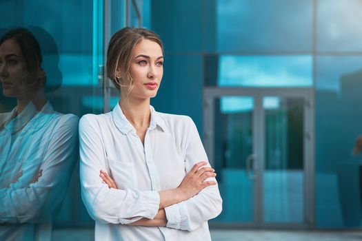 Businesswoman successful woman business person standing arms crossed outdoor corporate building exterior Pensive elegance caucasian confidence professional business woman middle age bank worker