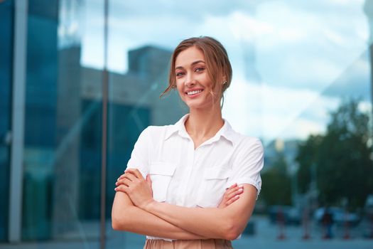 Businesswoman successful woman business person standing arms crossed outdoor corporate building exterior Smile happy caucasian confidence professional business woman middle age female entrepreneur