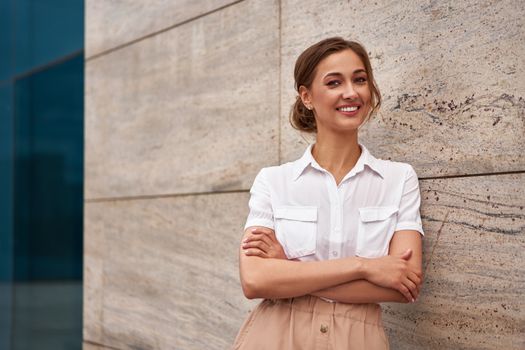 Businesswoman successful woman business person standing arms crossed outdoor corporate building exterior Smile happy caucasian confidence professional business woman middle age female entrepreneur