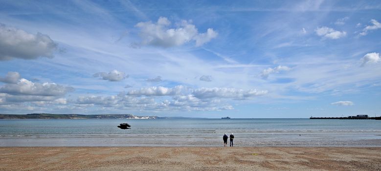 2 people starring out to sea on weymouth beach