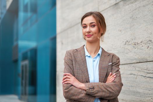 Businesswoman successful woman business person standing arms crossed outdoor corporate building exterior Pensive elegance caucasian confidence professional business woman middle age bank worker