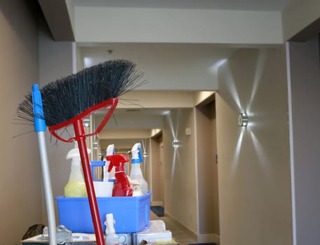 Cleaning concept: Hotel hallway with cleaners cart with cleaning equipment