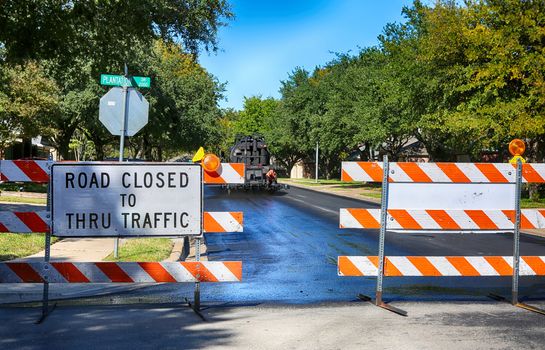 Green and quiet neighborhood street closed for maintenance.