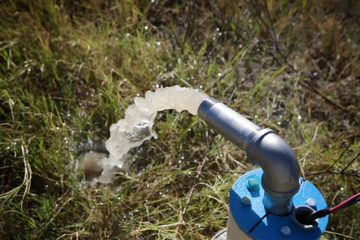 Unfinished draw-well pumping the first underground water.