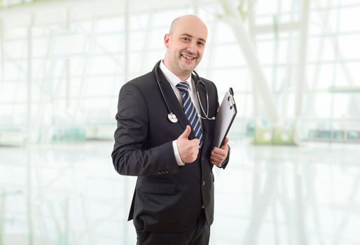 happy male doctor going thumb up, at the hospital
