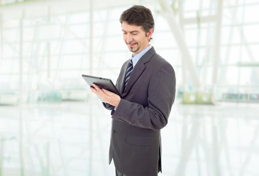 happy businessman with a tablet pc, at the office