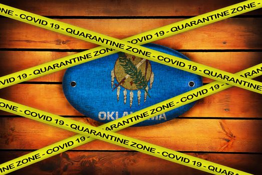 COVID-19 warning yellow ribbon written with: Quarantine zone Cover 19 on Oklahoma flag illustration. Coronavirus danger area, quarantined country.