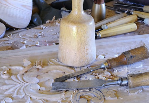 Working with carpenter tools to carve wood.