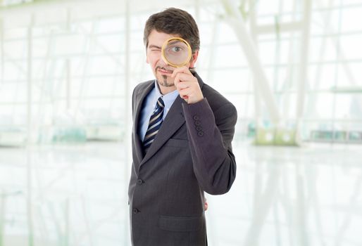 business man with magnifying glass at the office