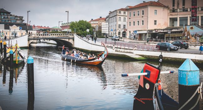 Aveiro, Portugal - May 7, 2018: view at the dock of the famous Moliceiros, traditional boats that used to harvest algae once and now transport tourists to the city canals