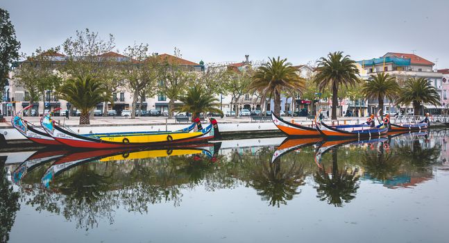 Aveiro, Portugal - May 7, 2018: Tourists walk on famous Moliceiros on a spring evening, traditional boats used to harvest seaweeds in the past