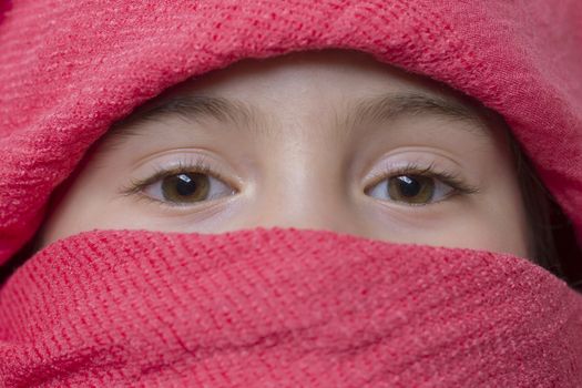 young girl with a veil covering her, close up, studio picture