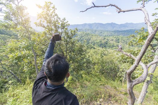 Man taking selfie on top of the mountain,Thailand