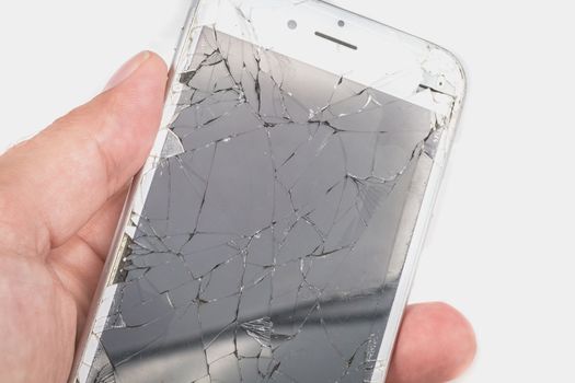 Paris, FRANCE - August 26, 2017: A man holds in his hand an iphone 6S of Apple Inc. whose screen is broken as a result of a violent fall