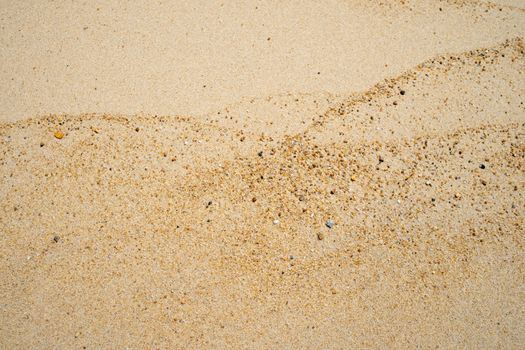 Brown sand texture background from fine sand with natural line wave on it.