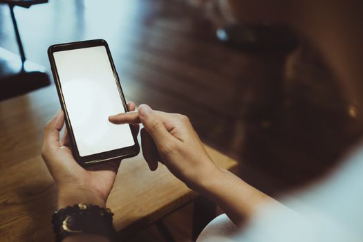 Woman hand use smartphone to do work business, social network, communication in public cafe work space area.