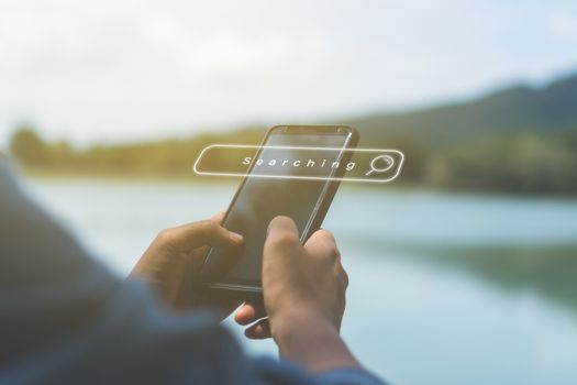 People hand using mobile phone or smartphone searching for information in internet online society web with search box icon and copyspace.
