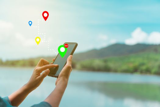 People use smartphone to check map to travel with internet and gps application for vacation or holiday.