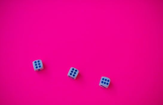 Three dice with number six isolated against pink background