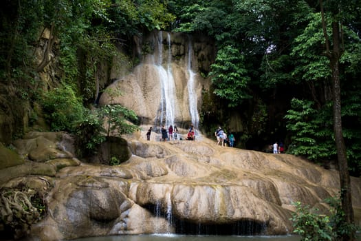 Tourists are enjoying the beauty of Sai Yok Noi waterfall.