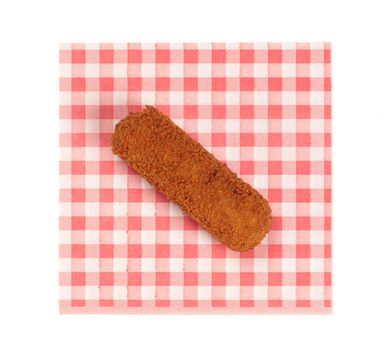 Brown crusty dutch kroket on a red napkin isolated on a white background
