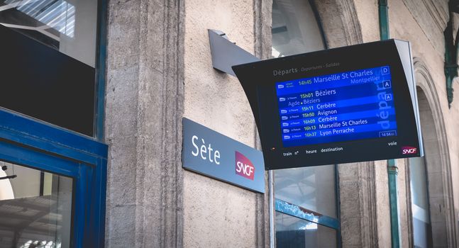 Sete, France - January 4, 2019: LCD display showing the departure of trains in the train station on a winter day