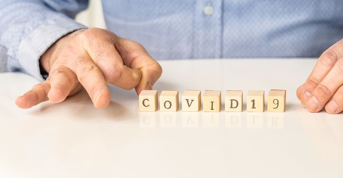 Covid 19 and coronavirus disease conceptual image on wood.