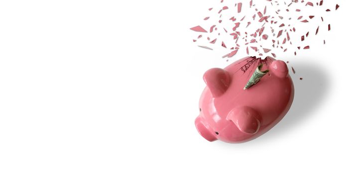 A breaking pink piggy bank with money and white background.
