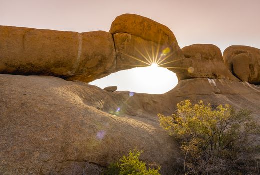 Rock arch at sunset in the Spitzkoppe National Park in Namibia in Africa.