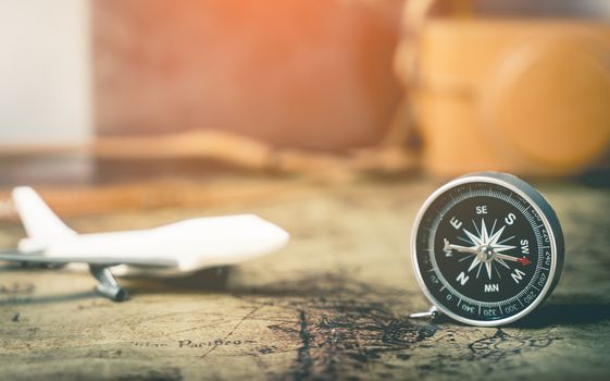 Plane compass and camera on vintage map