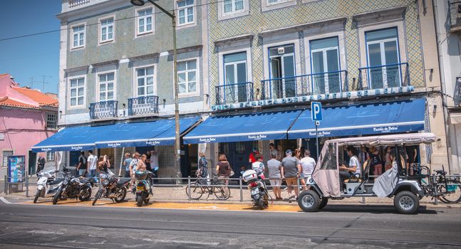 Lisbon, Portugal - May 7, 2018: People queuing in front of the famous bakery Pasteis Belem to buy the Pastel de Nata a spring day