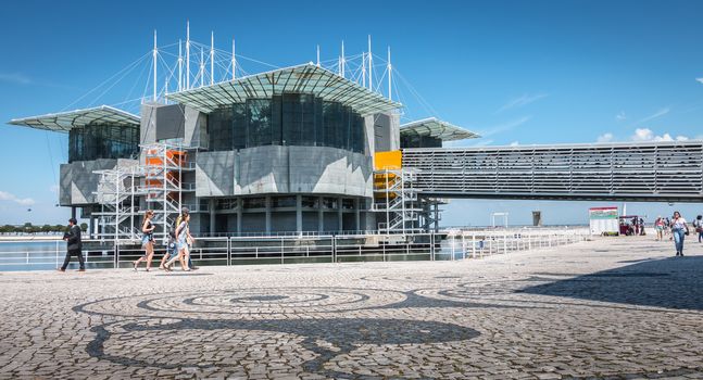 Lisbon, Portugal - May 7, 2018: people walking next to the Oceanarium of Lisbon a spring day. It is located in the Parc des Nations, a district created for the 1998 International Exhibition