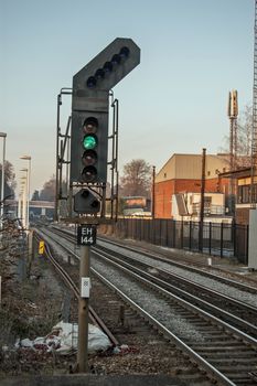 Hampshire, UK - February 11, 2012:  A single green light on a railway signal showing that the track ahead is clear for the driver to proceed.  Railway line in Hampshire, UK.